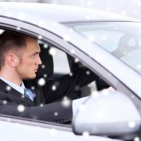 Business professional seated in the back of a chauffeur-driven car in Dubai
