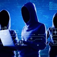 Hooded figures representing cybersecurity threats targeting corporate data